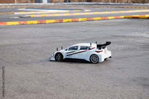 RC radio control model car at race track, modelling vehicle on the asphalt at a real extreme competition. Motor sport hobby.