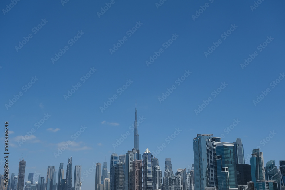 Futuristic and modern commercial and residential highrise tower skyscraper architecture with glass facades and clean lines in downtown Dubai, United Arab Emirates for millionaires and high society