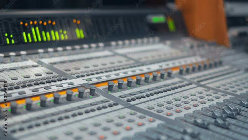 A closeup shot of a music equalizer at a recording studio