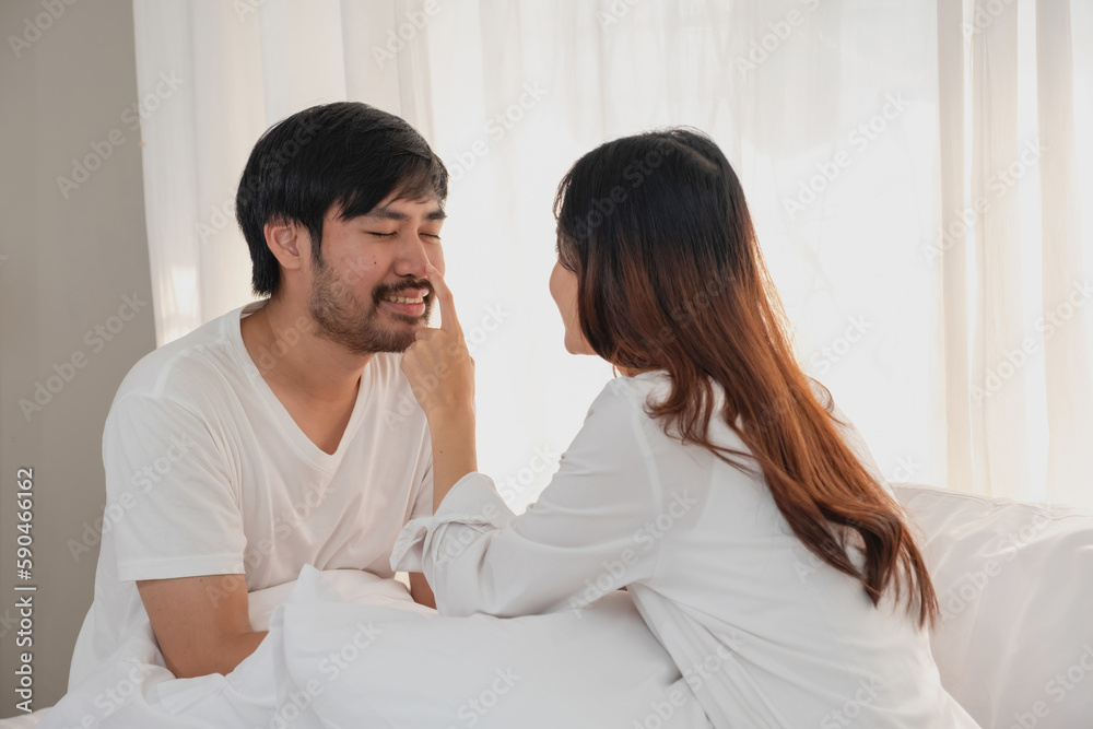 Happy young asian couple embracing, teasing, playing cheerfully in bed at home, romantic time to enhance family bonding. family concept. Happy young asian couple embracing, teasing, playing cheerfully in bed at home, romantic time to enhance family bonding. family concept.