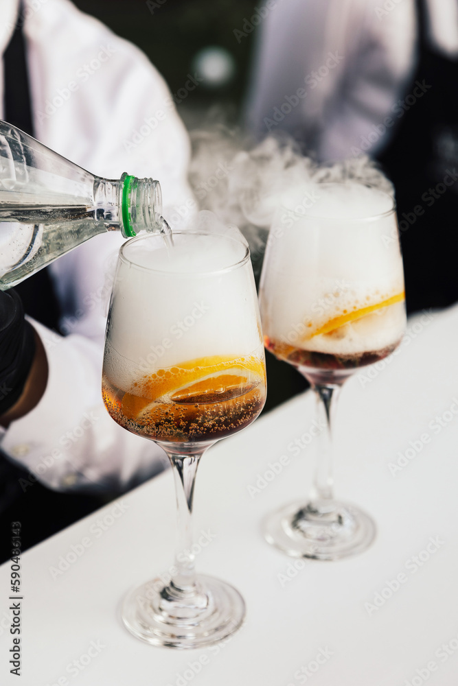 Fototapeta premium Bartender is preparing an Aperol Spritz in the bar.