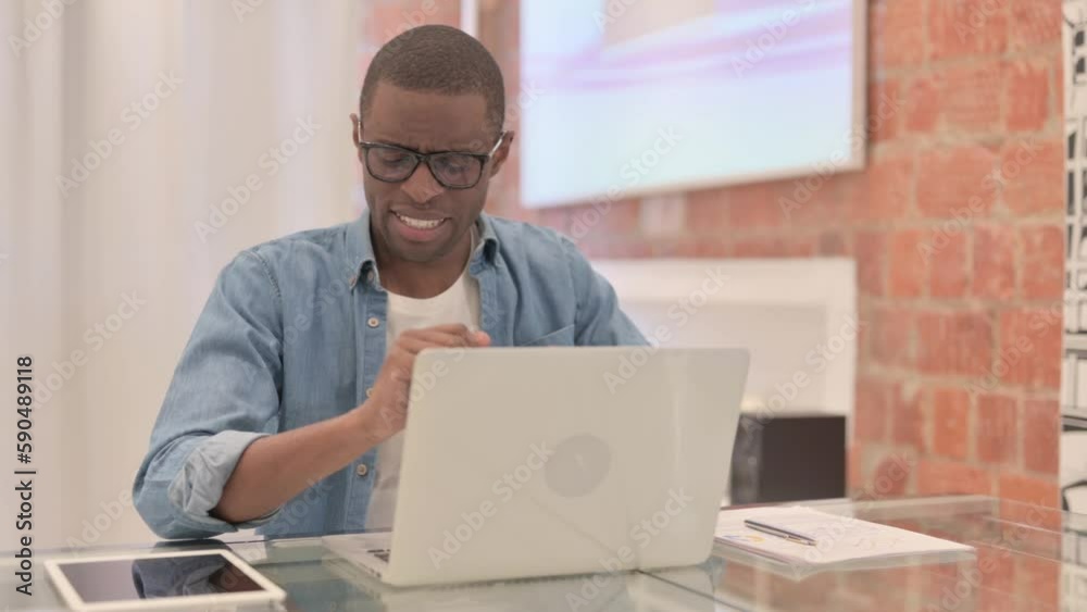African Man with Wrist Pain Working on Laptop African Man with Wrist Pain Working on Laptop