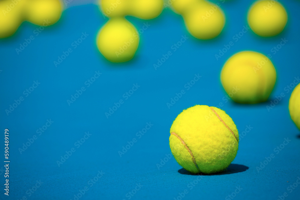  tennis balls on hard blue court