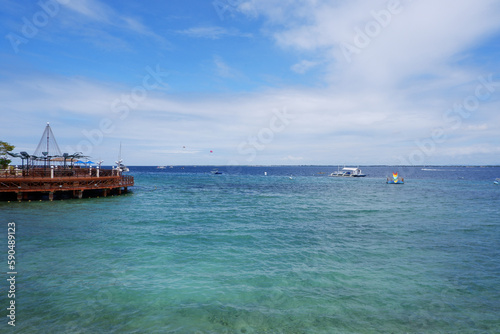 Blue ocean view with blue sky and wooden terrace. Beautiful blue sea view.
