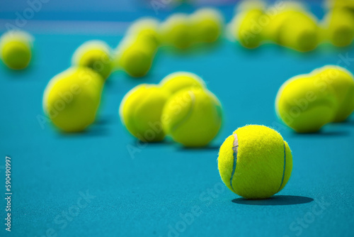 Tennis racket, balls and basket for tennis balls on hard blue court © Павел Мещеряков