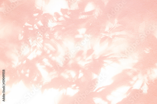 Leaf shadow and light on wall pink background. Nature tropical leaves tree branch and plant shade with sunlight from sunshine on wall texture for foliage background wallpaper, shadow overlay effect