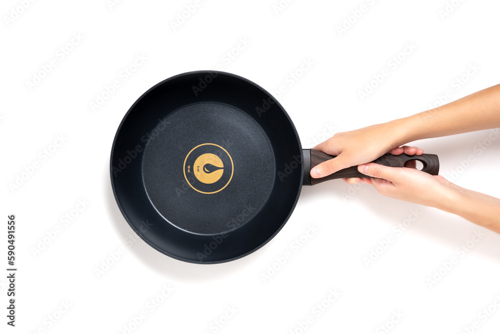 Fototapeta premium New Frying Pan in Hands Isolated on White