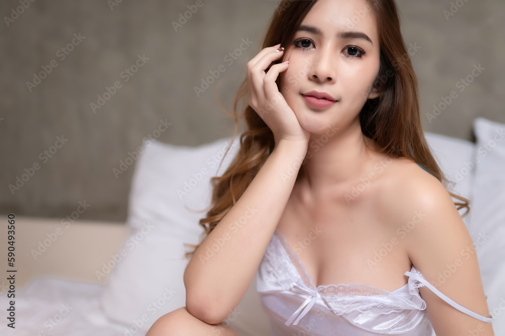 Portrait of asian sexy woman wear white dress in the bedroom Portrait of asian sexy woman wear white dress in the bedroom