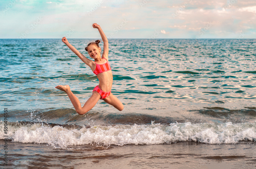 Jumping Child Girl Having fun Enjoying on Sea Beach. Happy Family Summer Holiday with Children. Jumping Child Girl Having fun Enjoying on Sea Beach. Happy Family Summer Holiday with Children.