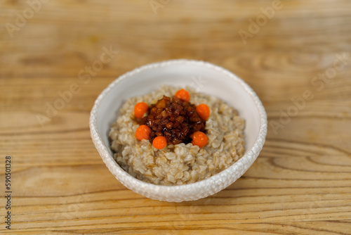 professional kitchen freshly prepared oatmeal with caramelized fruit for breakfast in a restaurant healthy food concept