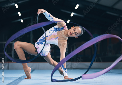 Ribbon, gymnastics and woman dancer in performance, action and sports competition. Female, rhythmic movement and flexible dancing athlete, creative skill and talent of concert event in practice arena