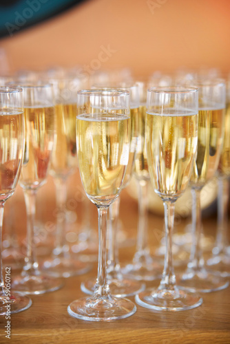 close up arranged glass on the table in abstract field in celebration time for any luxury background. many glasses of champagne, close-up, bokeh