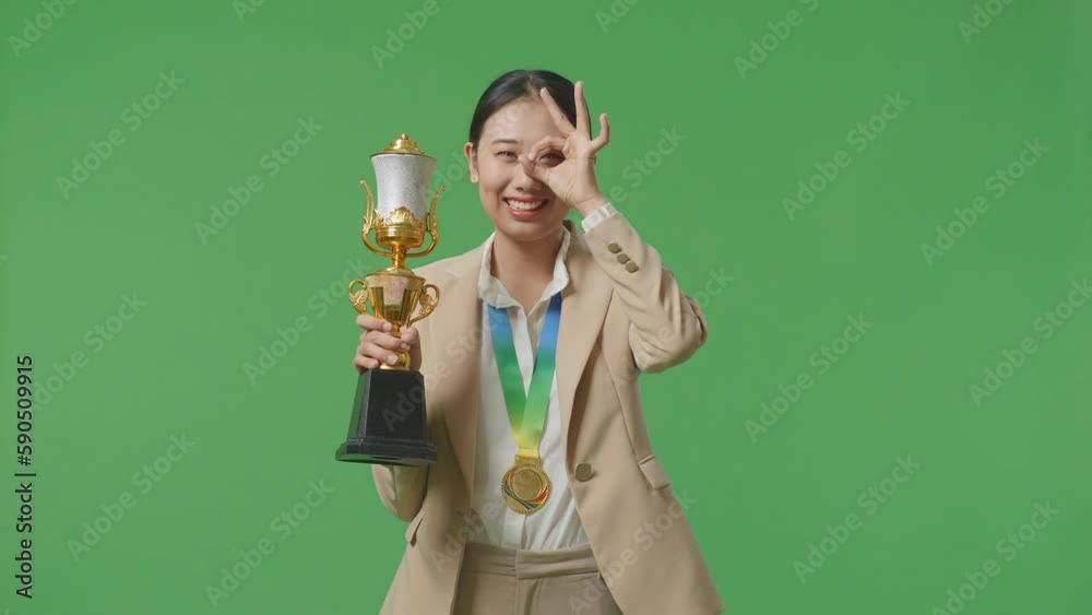 Asian Business Woman In A Suit With A Gold Medal And Trophy Showing ...