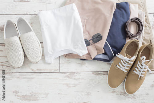 Fotografie mens summer basic clothes and shoes on old wooden floor