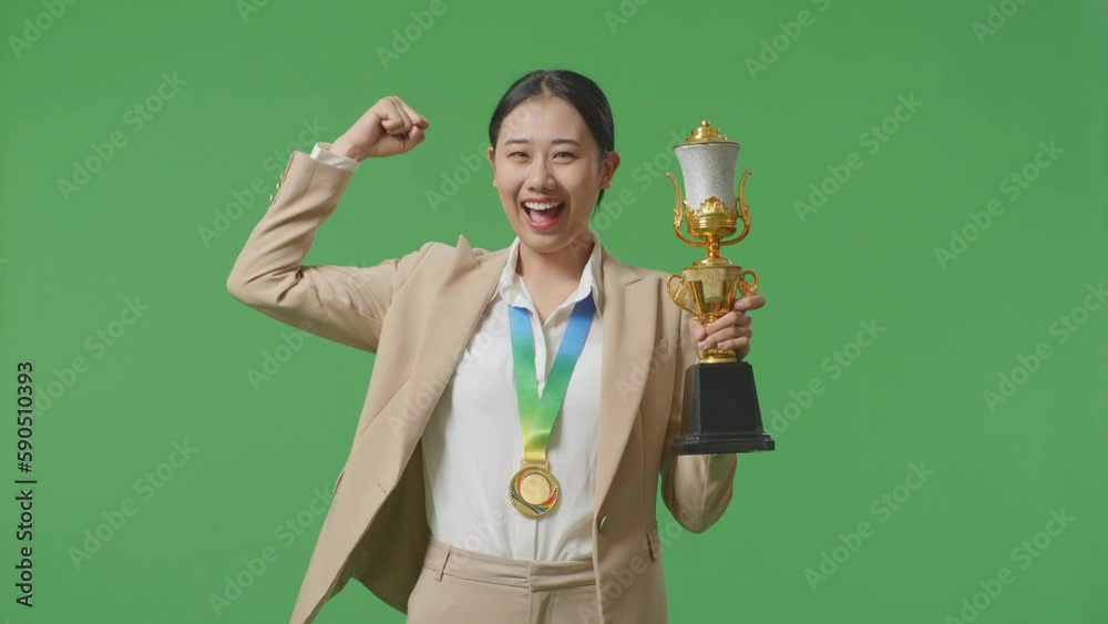 Asian Business Woman In A Suit With A Gold Medal And Trophy Flexing Her ...