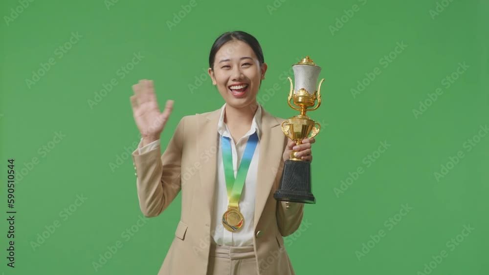 Asian Business Woman In A Suit With A Gold Medal And Trophy Waving Her ...