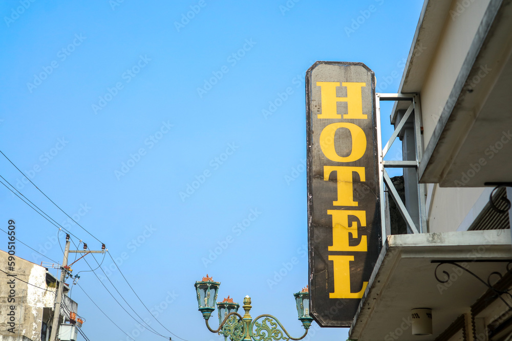 Fototapeta premium Old hotel sign with clear blue sky in Yogyakarta, Indonesia
