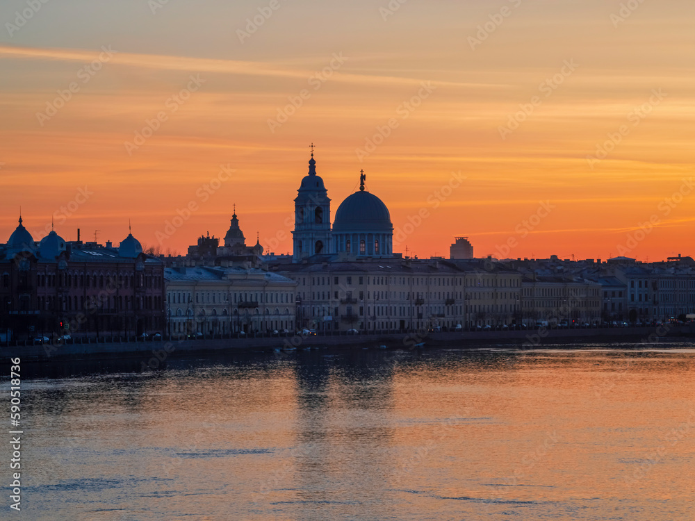 Golden spring sunset in city. Saint Petersburg cityscape over Neva River in Russia. City skyline colorful photo with historical Russian architecture. Postcard view of the city.