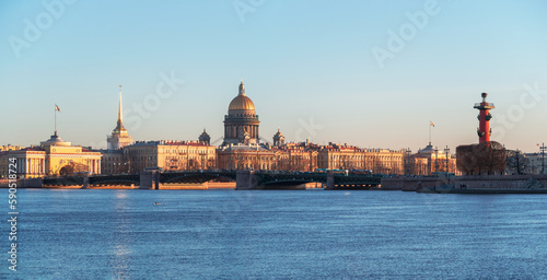 Panorama of spring St. Petersburg with a view of St. Isaac's Cathedral. View from the Neva River. Sunset view of the Palace Bridge, city life, postcard views of the evening city.