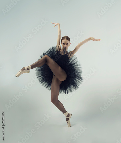 Leinwand Poster ballerina in a black tutu shows elements of ballet dance in motion