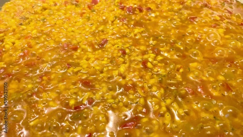 Paella simmering in a paella pan, as a typical dish of Spanish cuisine. Close-up, concepts, 4k resolution.