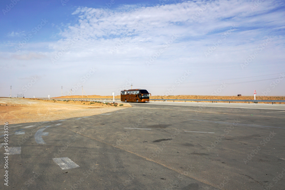 Bus on the road across the plain Bus on the road across the plain