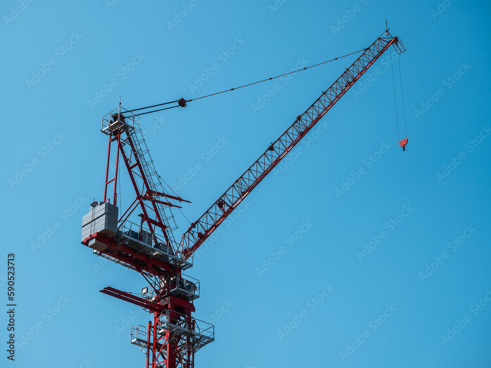 Building under construction, cranes and high-rise building