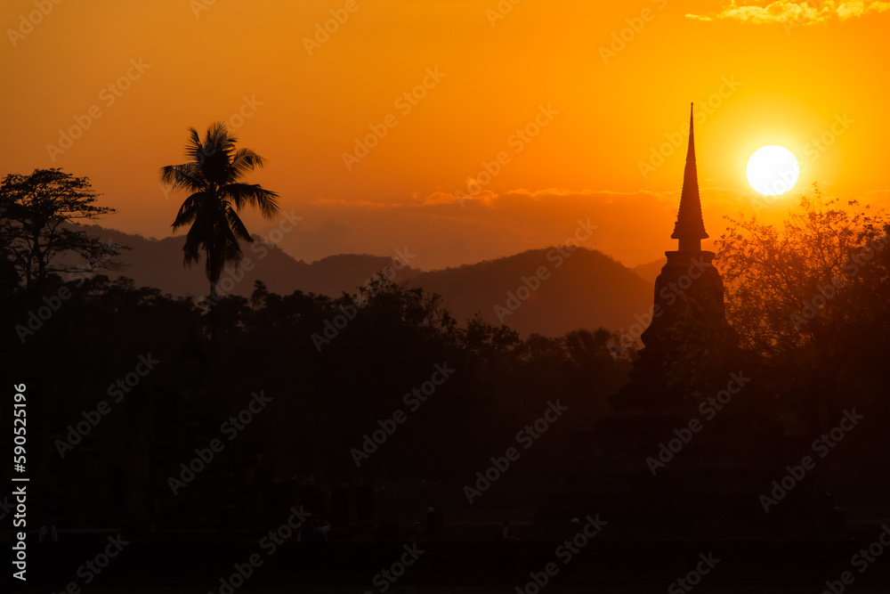 Ancient temples in Sukhothai Historical Park, Thailand, orange sunset