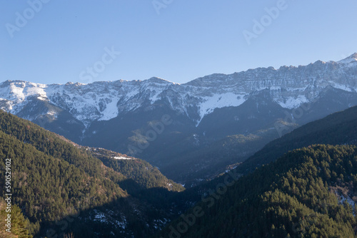 Sunset in some snowy mountains surrounded by pine forests © Rafael Prendes