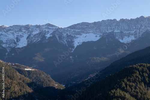 Sunset in some snowy mountains surrounded by pine forests © Rafael Prendes