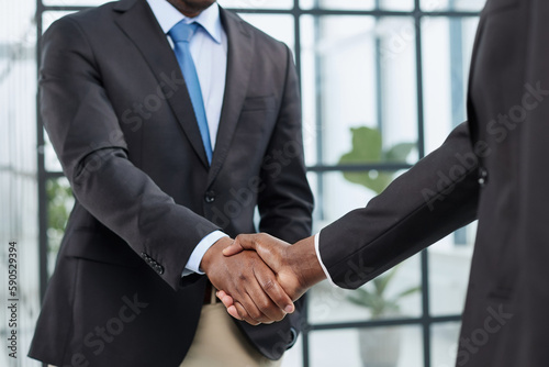 Businessman shaking hands with colleagues. Handshake at meeting