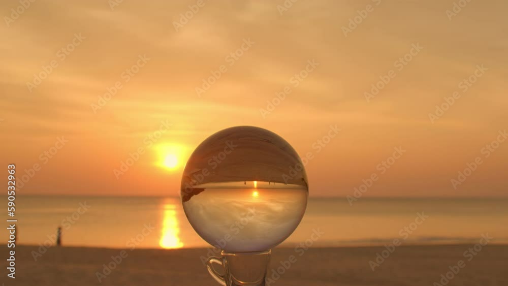 beautiful cloud in sky of sunrise inside crystal ball beside the beach..beautiful nature in a crystal ball by the sea..Unique and creative travel and nature idea. beautiful cloud in sky of sunrise inside crystal ball beside the beach..beautiful nature in a crystal ball by the sea..Unique and creative travel and nature idea.