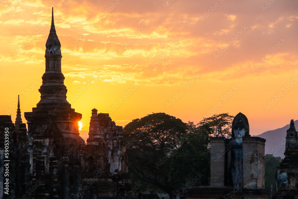 Ancient temples in Sukhothai Historical Park, Thailand, orange sunset