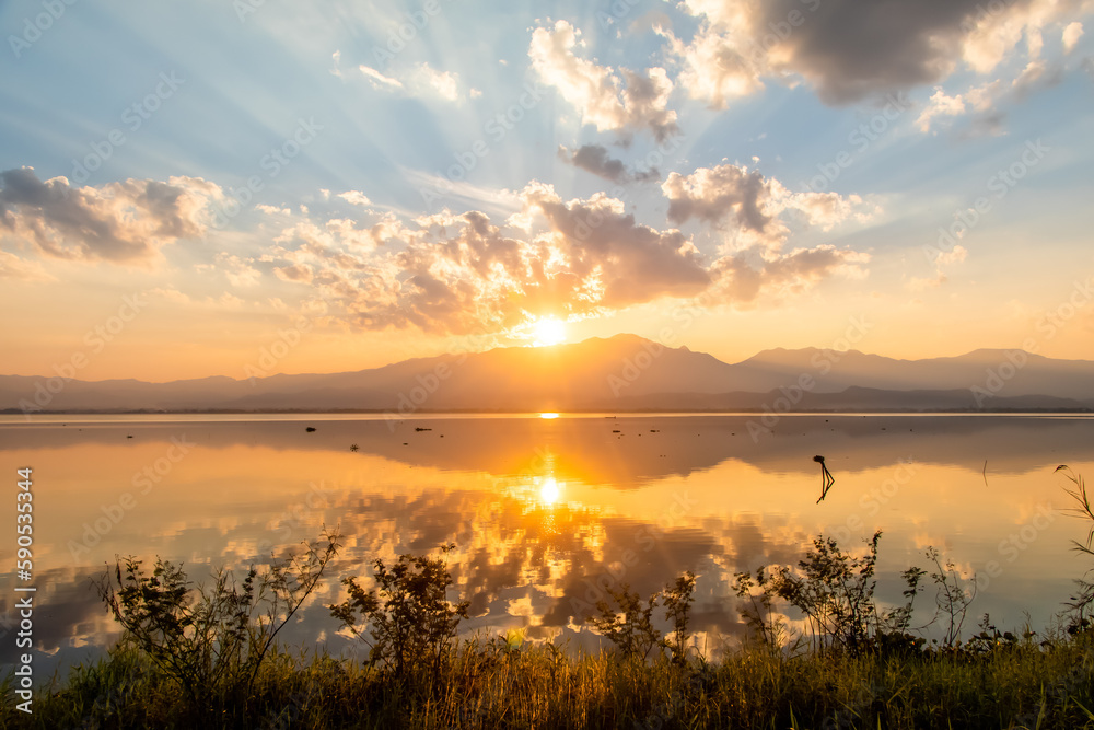 Sunset over lake Phayao with reflection and bright colourful sky. 