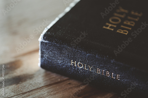 Holy bible book for education on wooden table with background. Christian catholic with protestant worship and pray in church. Concept of learning about faith god and religion, jesus spiritual.