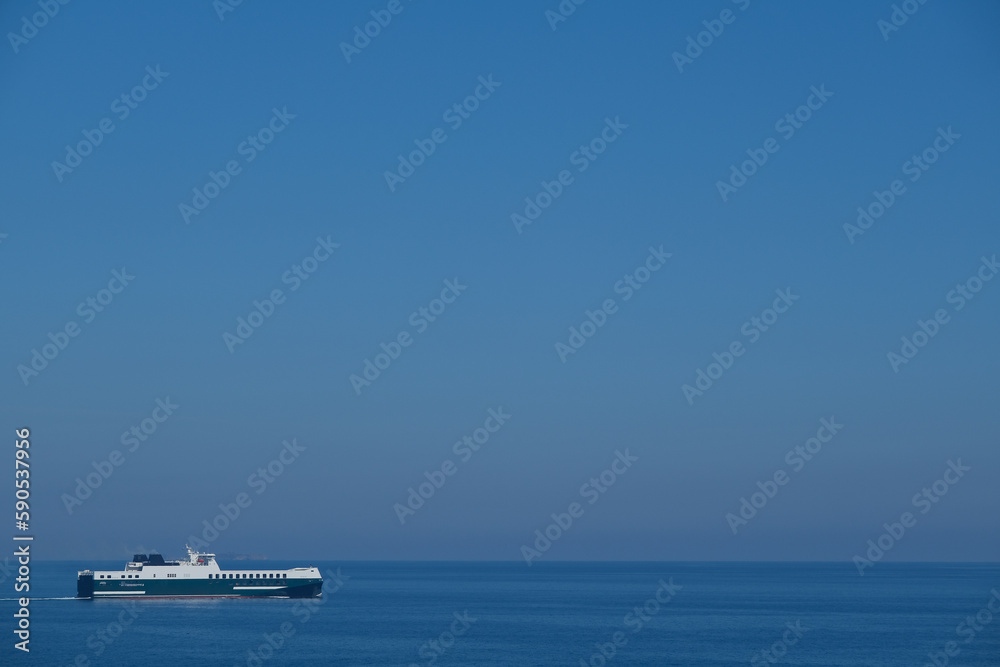 Passenger pax cargo car roro ro-ro ferry at sea with blue ky