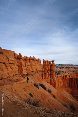 Vertical shot of a person standing on mountain in Bryce Canyon National Park, Utah, USA