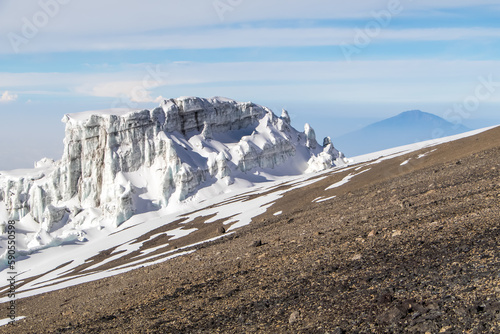 Glaciers and ice on the slope of Mount Kilimanjaro. Bright sunlight 