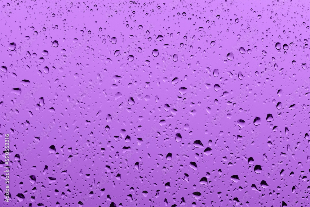 Macro photography of purple rain drops on the window glass Macro photography of purple rain drops on the window glass