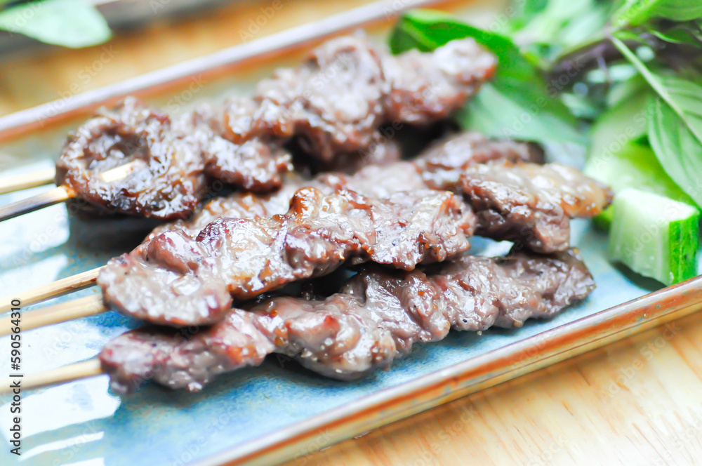 barbecued beef or grilled beef , beef satay with sauce