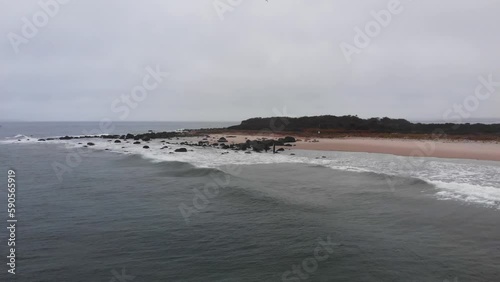 Gloomy and grey ocean beach in the winter aerial footage