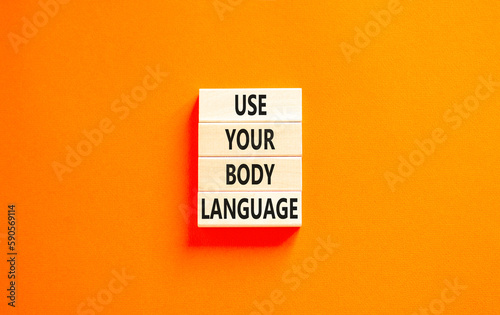 Use your body language symbol. Concept words Use your body language on wooden block. Beautiful orange table orange background. Motivational business use your body language concept. Copy space.