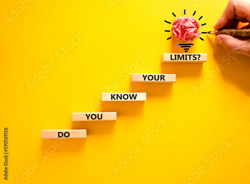 Do you know your limits symbol. Concept words Do you know your limits on wooden block. Beautiful yellow table yellow background. Businessman hand. Business do you know your limits concept. Copy space.
