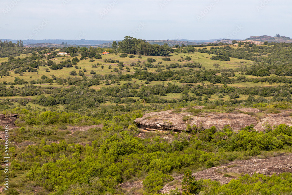 Geological formations, farm field and forest