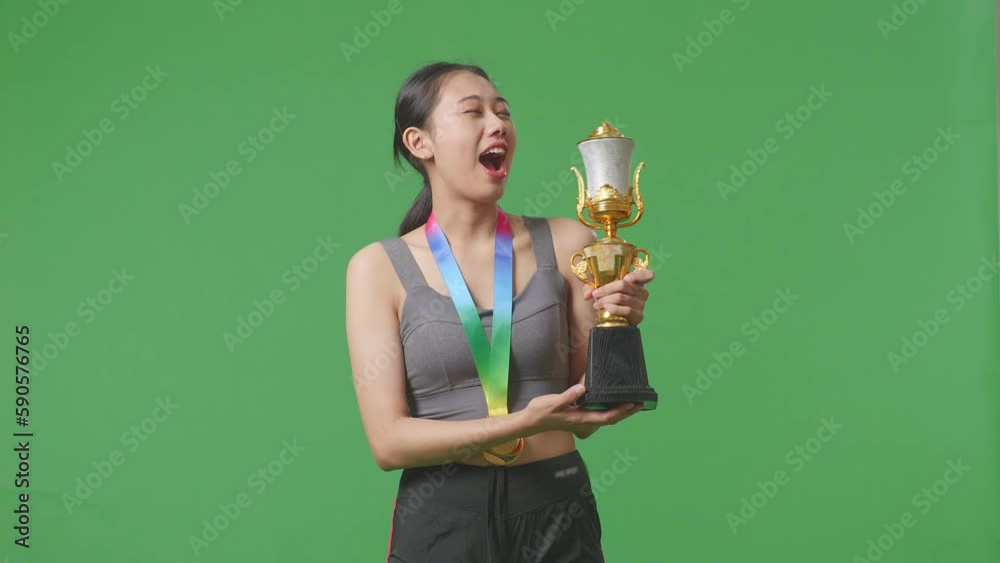 Asian Woman With A Gold Medal Kissing A Gold Trophy Being Proud Winning ...
