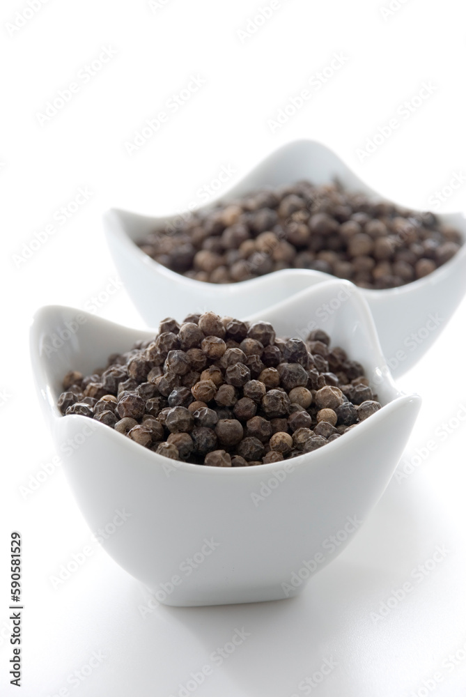 Close up of Black peppercorn in white bowl isolated on white background. Close up of Black peppercorn in white bowl isolated on white background.