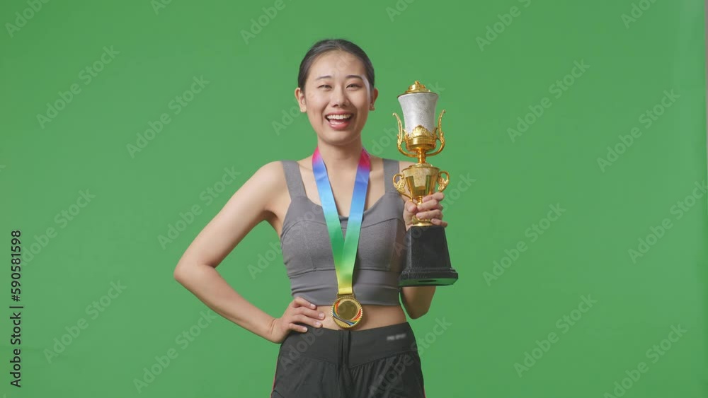 Asian Woman With A Gold Medal And Trophy Smiling To Camera With One Arm ...