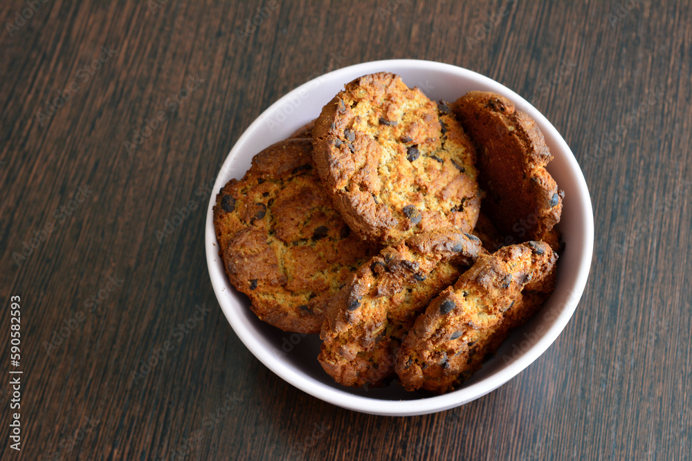 A bowl of oatmeal cookies on a table isolated, close-up A bowl of oatmeal cookies on a table isolated, close-up