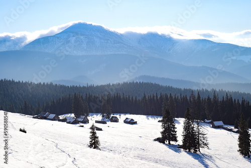 Valley of shepherds with houses in the mountains. View of the highest peaks of Chornohora range (Сarpathian Mountains, Ukraine)