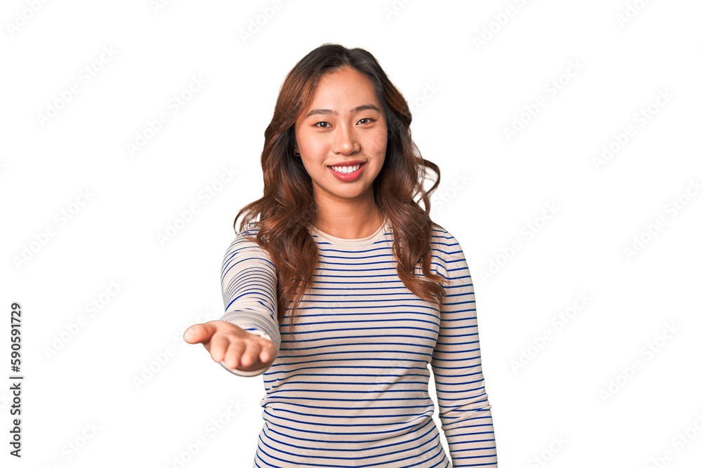 A young chinese woman stretching hand at camera in greeting gesture. A young chinese woman stretching hand at camera in greeting gesture.